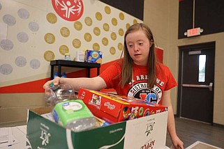 Courtesy/Jefferson City School District
Jefferson City High School junior Sophia Backues boxes a grocery order in the "We are the Champions" life skills showcase Friday. The event is designed to give students a chance to share the employability skills they have been practicing all year.